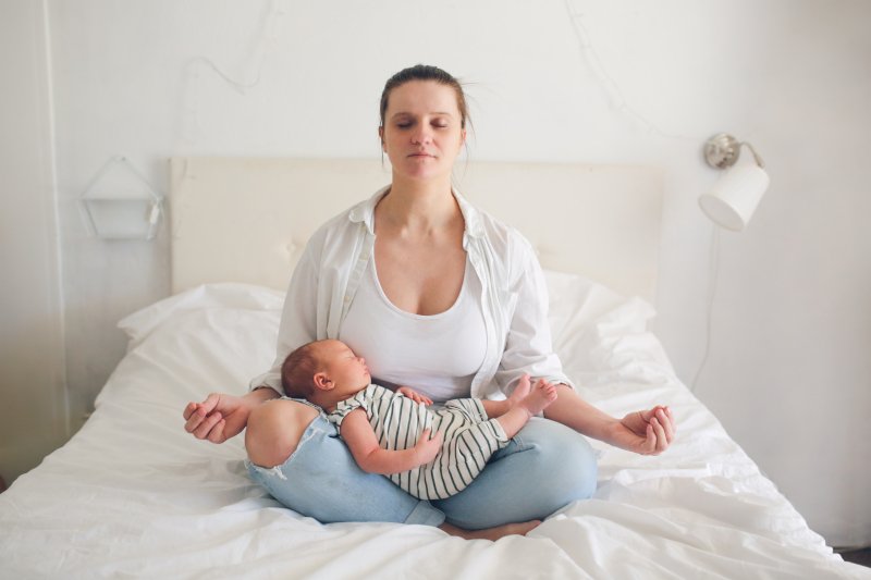 woman meditating with baby